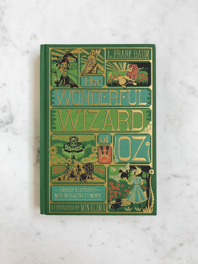 The green cover of The Wizard of Oz displaying multiple characters and scene art, with the title in a large gold lettered font.