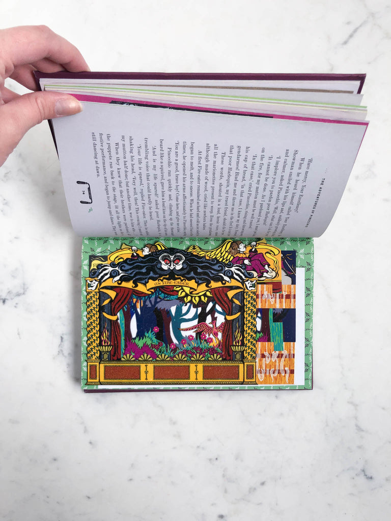An open page of a colorful and detailed art of a scene from the story of Pinocchio.
