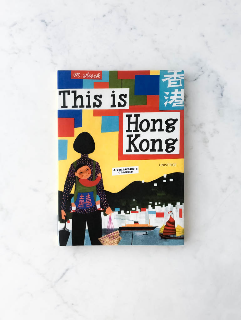 Colorful children's book labeled "This Is Hong Kong" with a child wrapped onto mothers back.