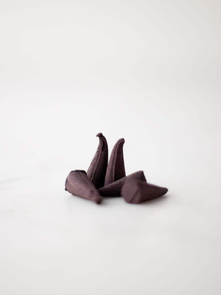 Four incense cones complied together on a table.