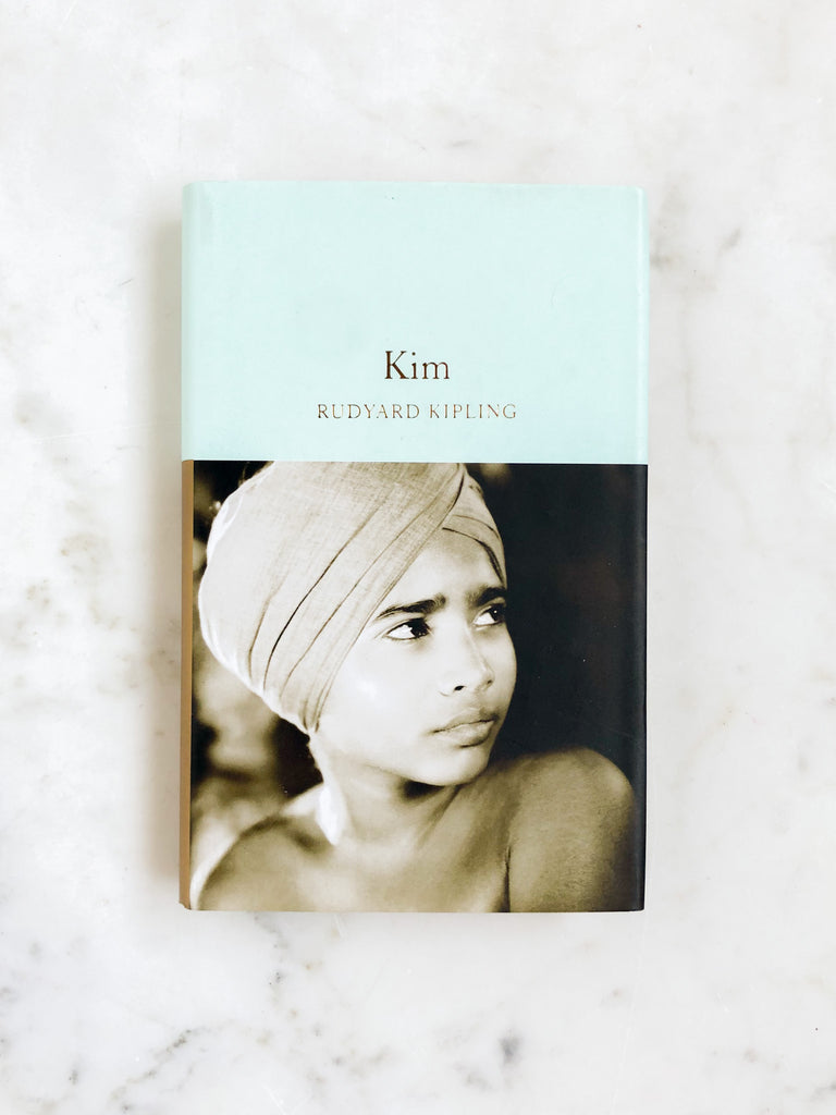 A blue book titled “Kim” in gold lettering with a boy in a turban on the cover. 