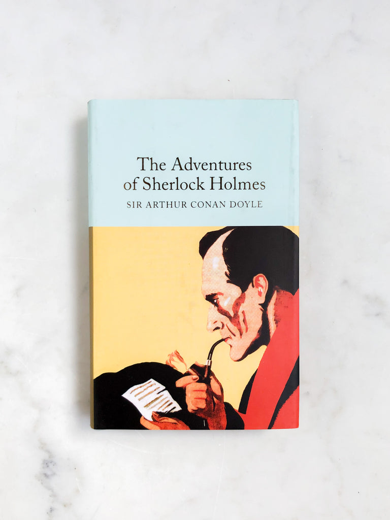 A light blue pocketbook entitled “The Adventures of Sherlock Holmes”. The cover illustration is yellow and shows Holmes smoking a pipe while reviewing notes.