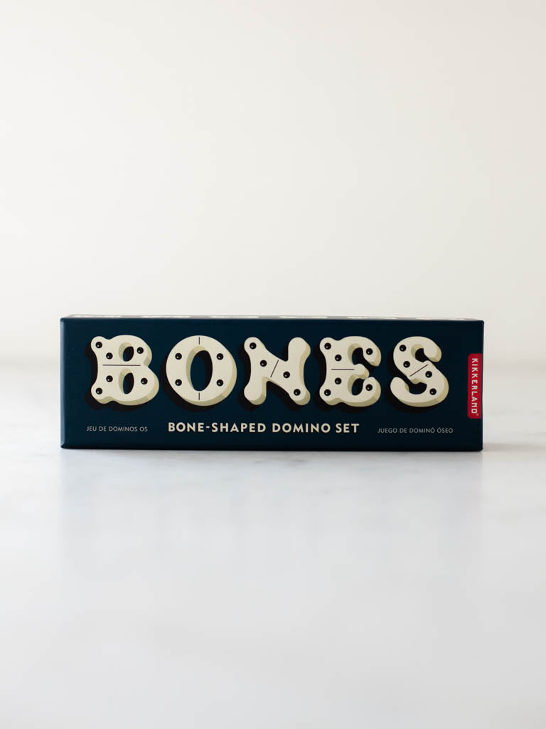 Blue box that the set of dominoes comes in. The box is labeled “Bones: Bone shaped domino set”.