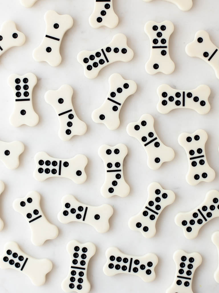 Dominoes scattered over a quartz countertop.
