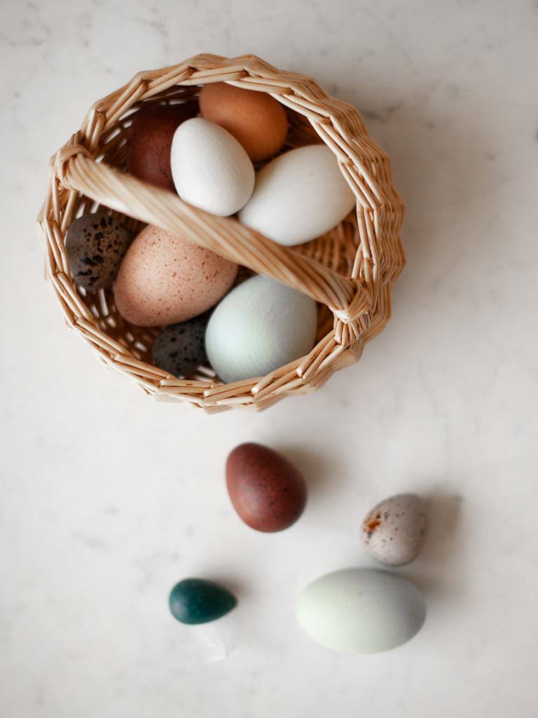 Basket with various sizes and colors of eggs