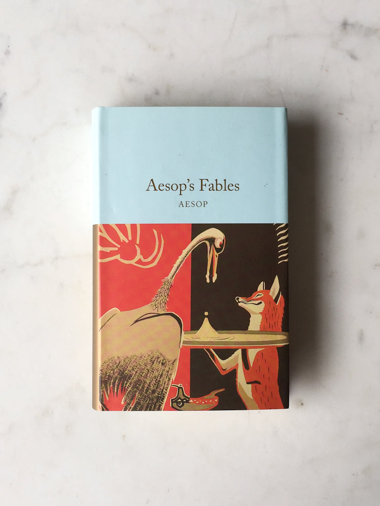 Light blue book entitled “Aesop’s Fables”. The illustration is red and black. It features a sly fox serving a crane.